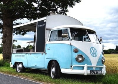 VW Pizza Van with split screen conversion and woodfired pizza ovens at an event on a nice day