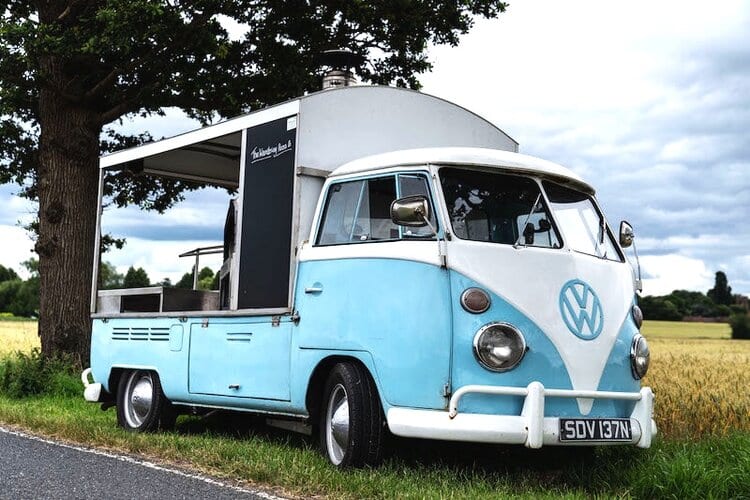 VW Pizza Van with split screen conversion and woodfired pizza ovens at an event on a nice day