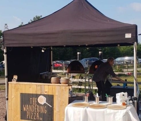 The wandering pizza gazebo with portable wood-fired pizza ovens in a streetfood setup